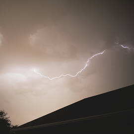 Lightning Illuminates Night Sky by Brandon Wichmann