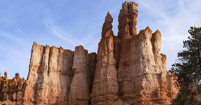Architecture Wall Art featuring the photograph Majestic Rock Formations Under Blue Sky In Bryce Canyon National Park by Brandon Wichmann