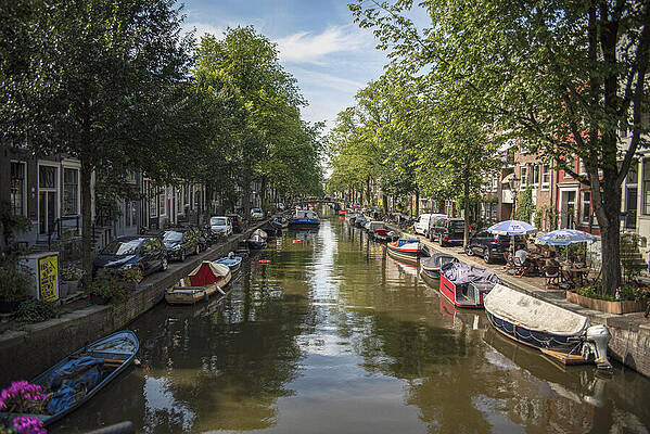Serene Wall Art featuring the photograph Serene Amsterdam Canal With Boats And Trees by Brandon Wichmann