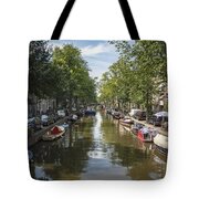 Serene Amsterdam Canal With Boats And Trees Tote Bag
