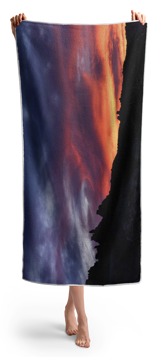 Vivid Twilight over Rocky Silhouette Beach Towel