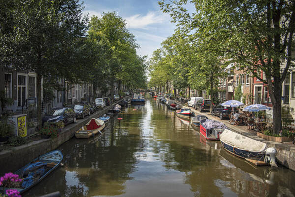 Serene Amsterdam Canal With Boats And Trees Poster