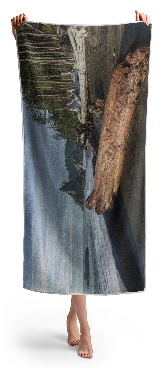 Driftwood on a Pebbled Beach Beach Towel