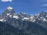 Snow-capped Teton Mountain Peaks Under Blue Sky Jigsaw Puzzle